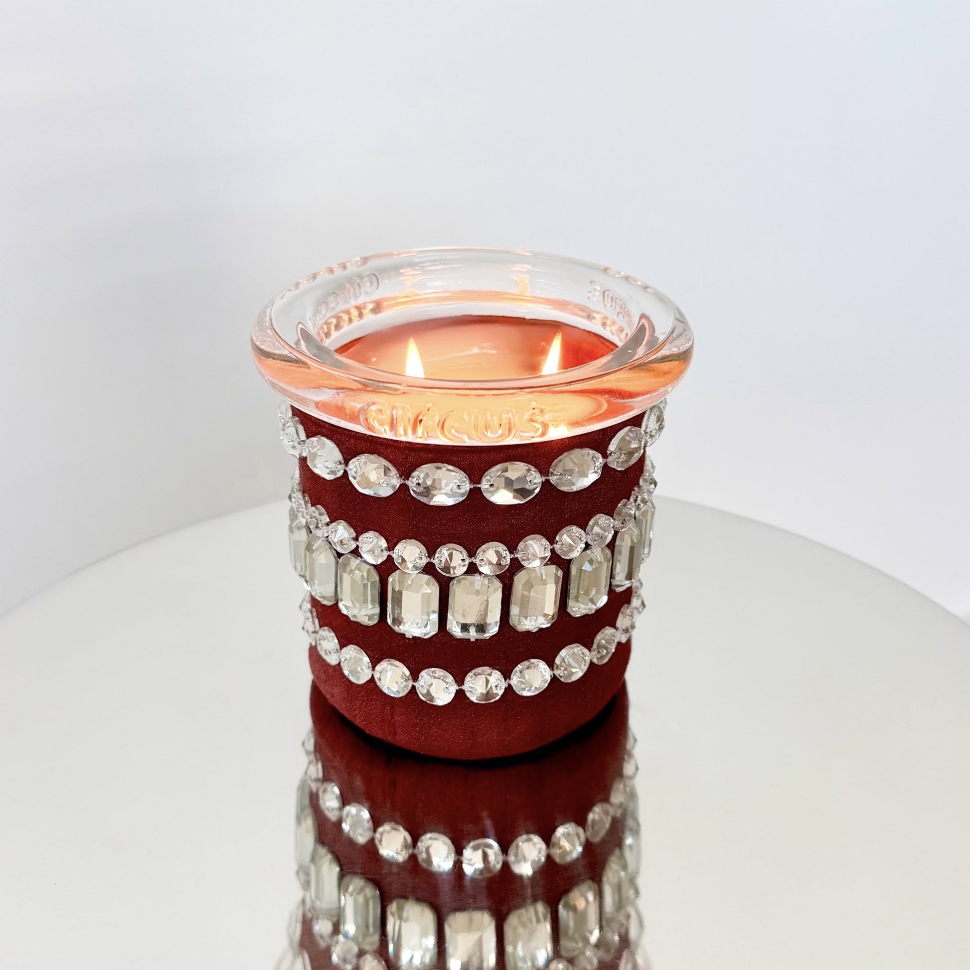 circus candle with crystals on a shiny surface
