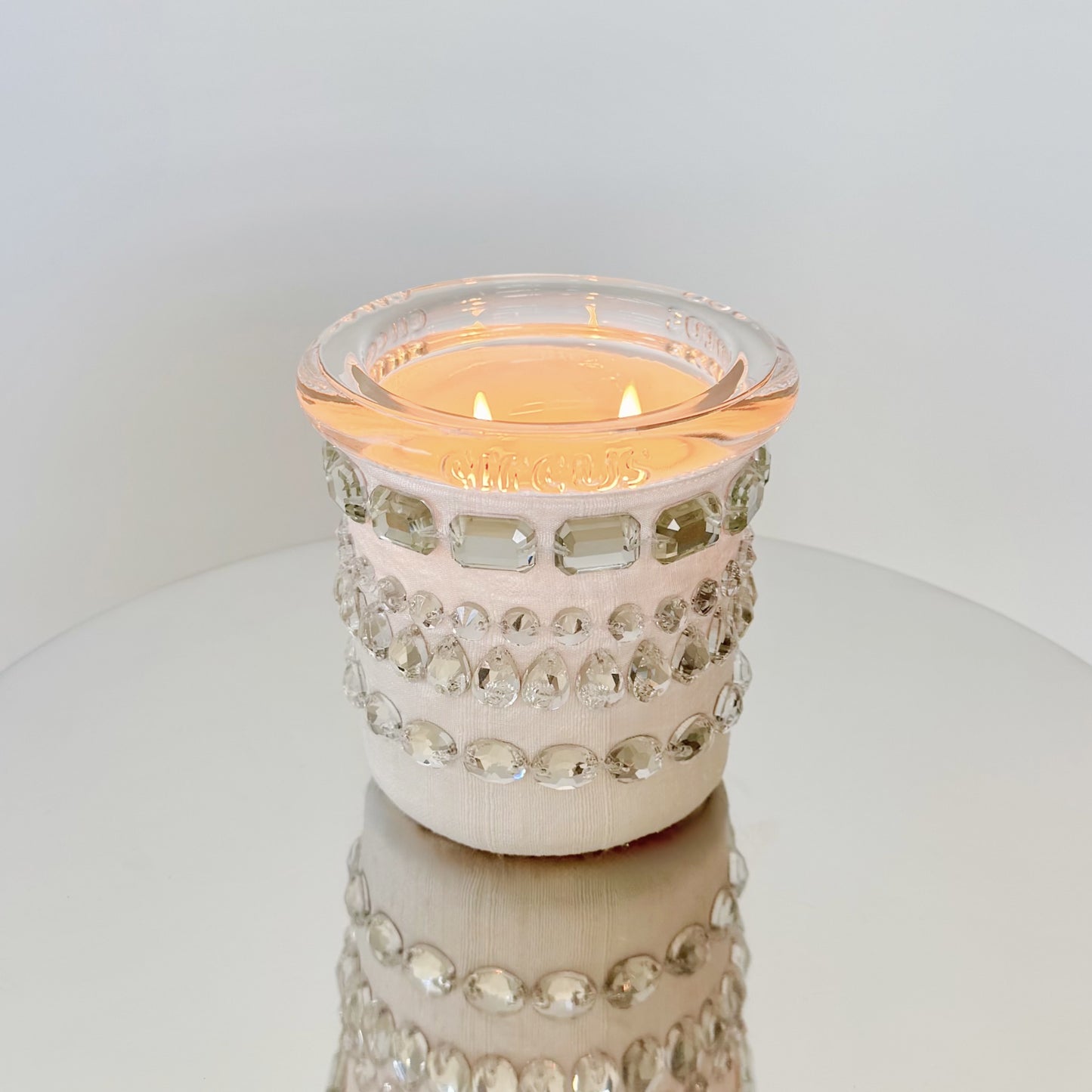 circus brand candle with crystals candle on a white surface