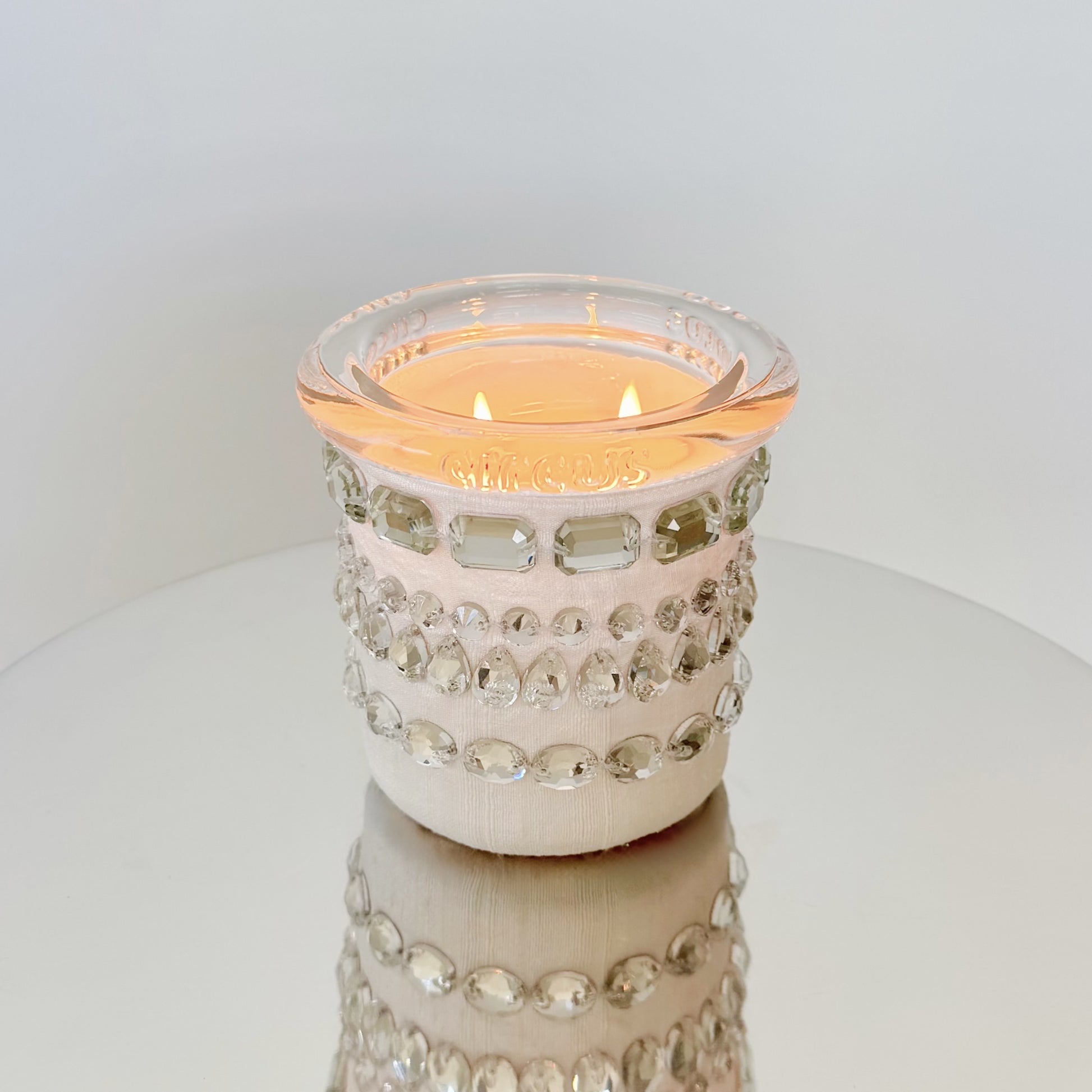 circus brand candle with crystals candle on a white surface
