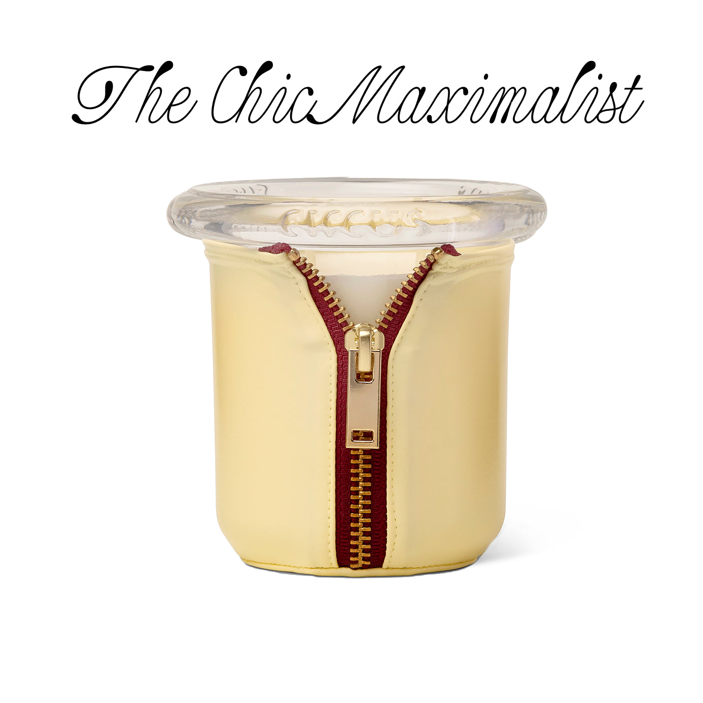 candle with gold zipper on a white background, featuring 'The Chic Maximalist' text.