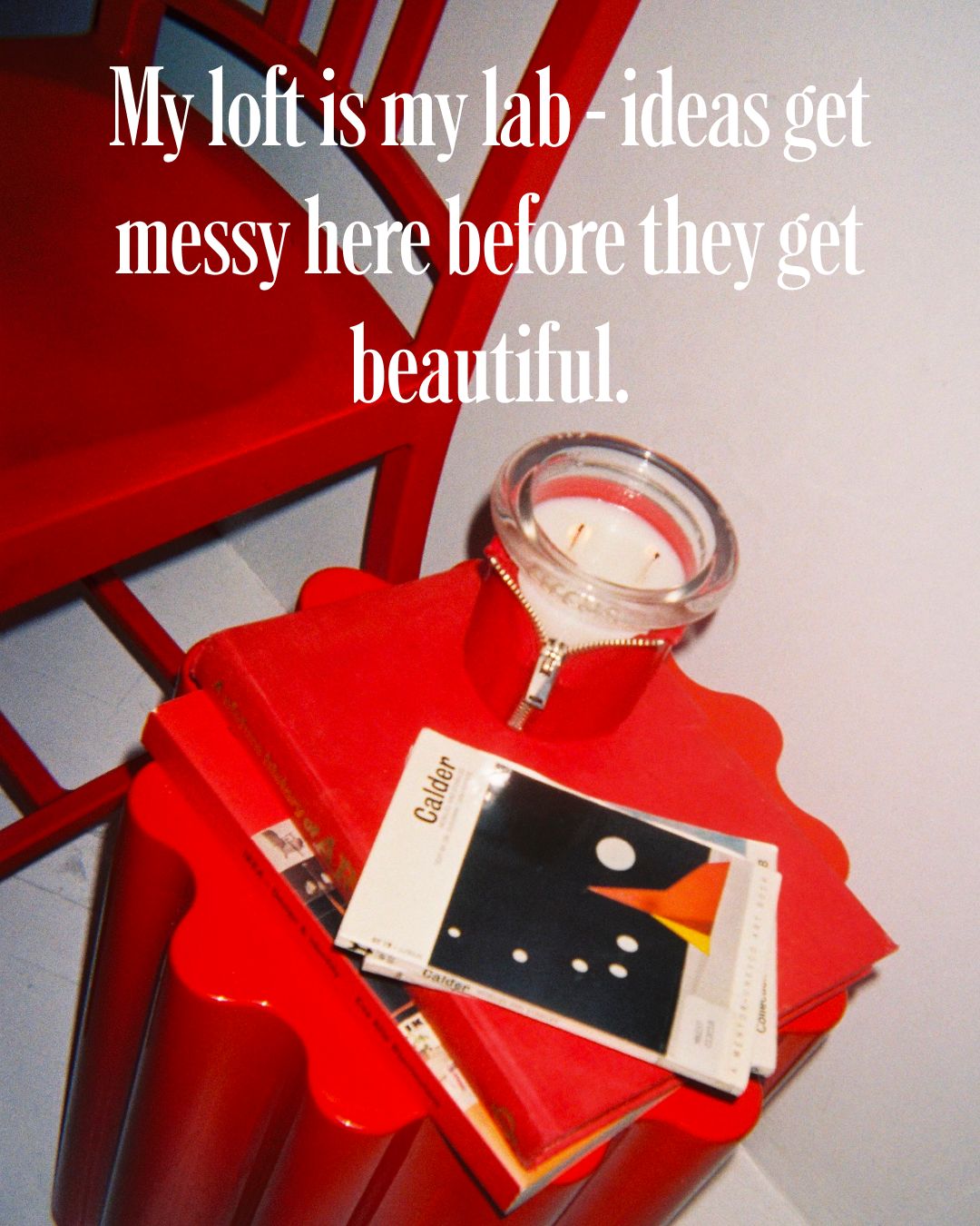 sophie colle red side table  with books and a circus bound candle  in red on a white background, featuring text about a creative workspace.