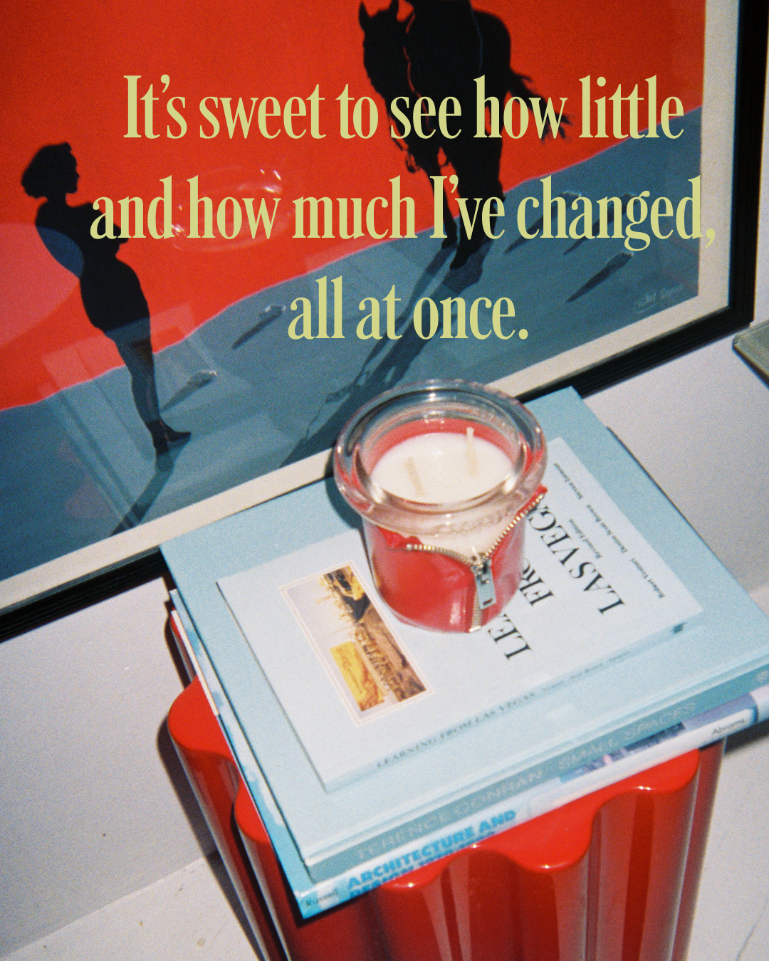 circus bound candle on a book with a poster in the background featuring silhouettes of a woman and a horse