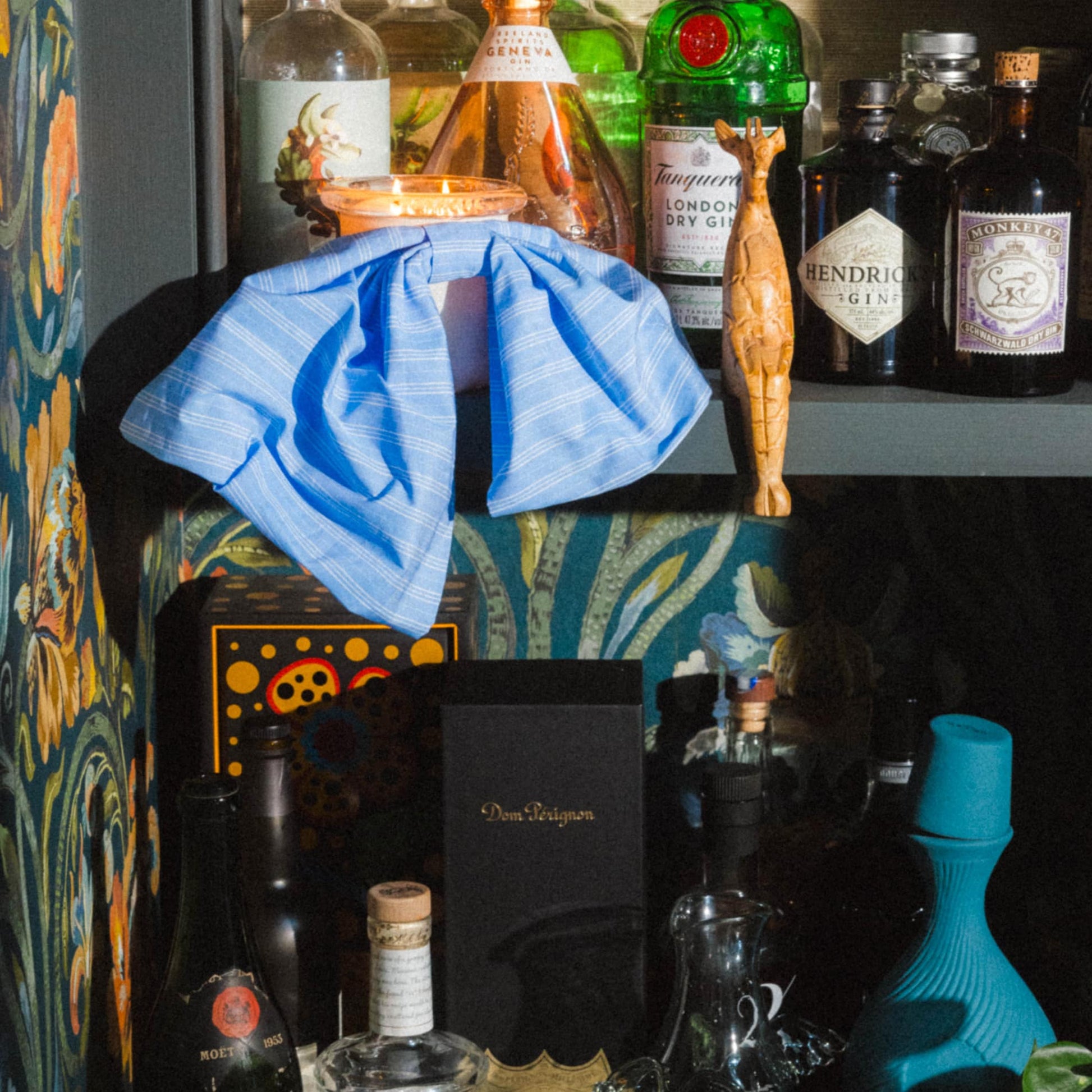 Art Director Colson Horton's bar styled with Bow Baby candle in french and cream surrounded by alcohol