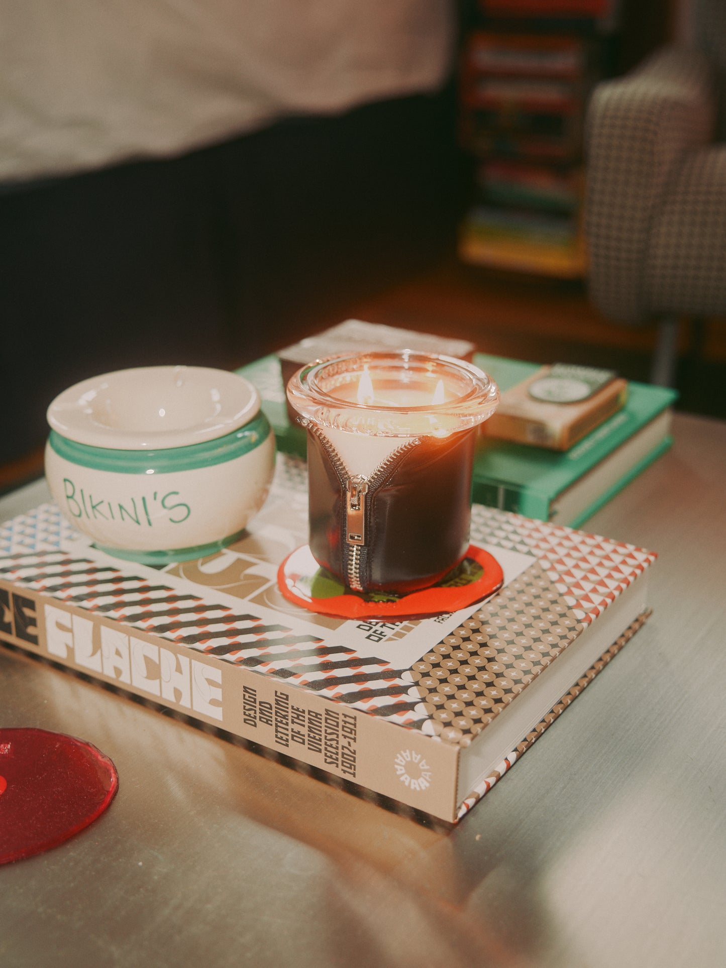 Decorator Conor Burke's NYC studio with Bound Black candle styled on metal coffee table 