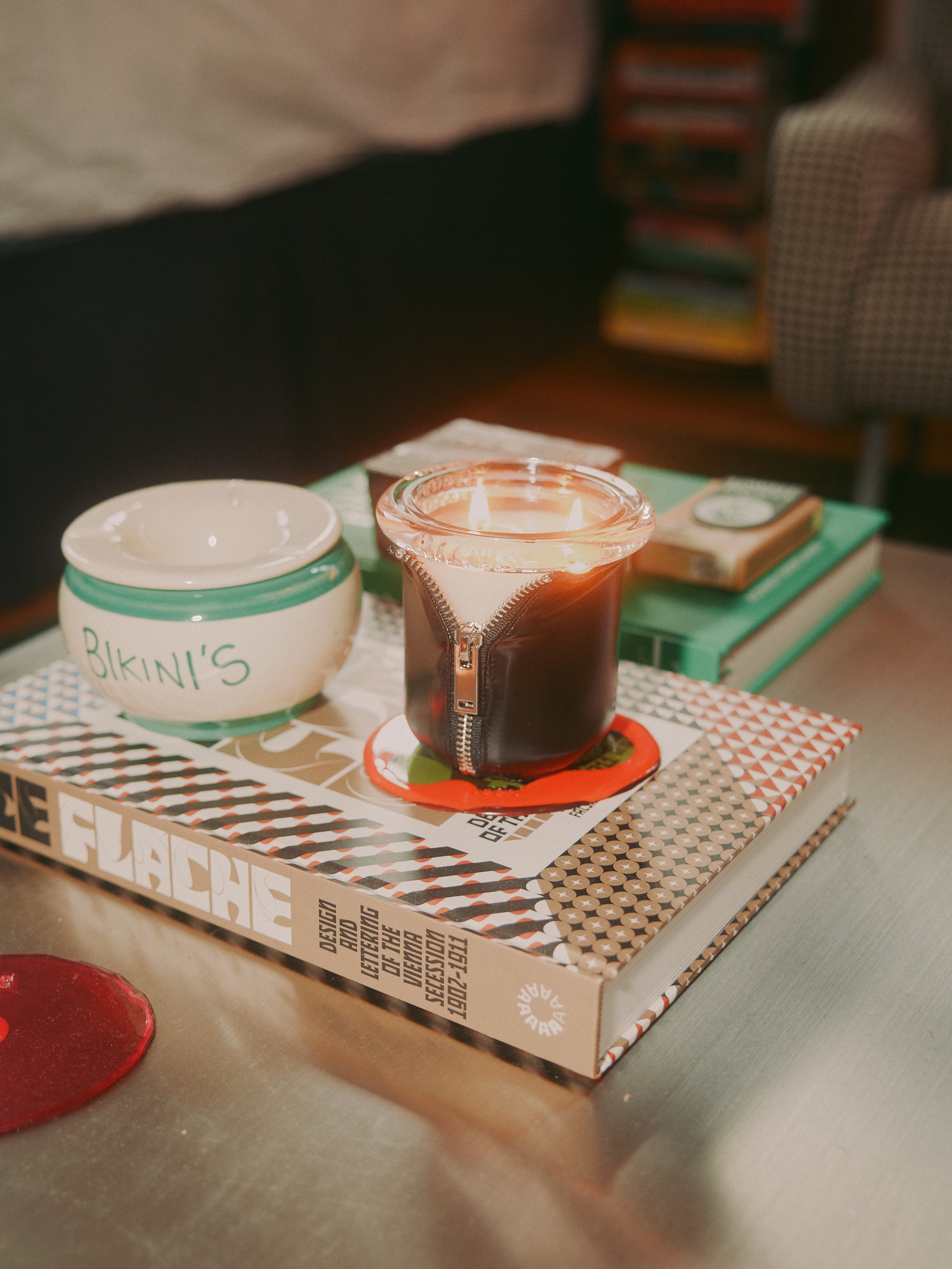 Decorator Conor Burke's NYC studio with Bound Black candle styled on metal coffee table 