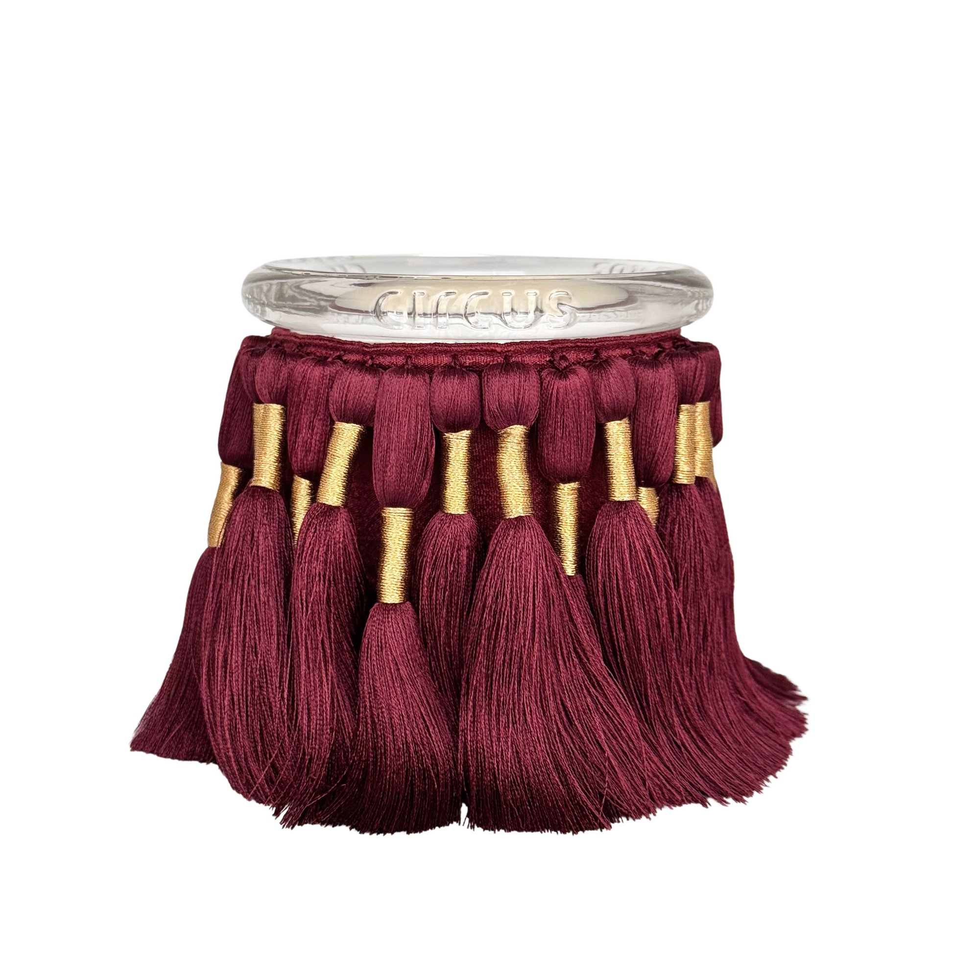 fuzzed candle with burgundy silk tassels and featuring a warm and soft fragrance