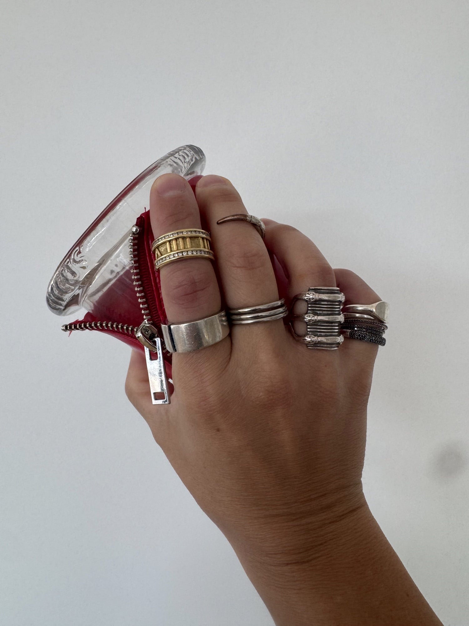 circus founder lee lenox shows off his collection of fine jewelry while holding bound candle red